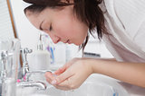 Young woman washing face