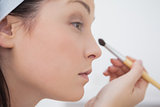 Closeup woman putting on makeup
