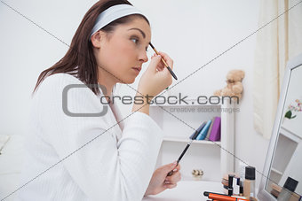 Woman putting on makeup