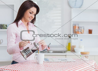 Young woman pouring coffee
