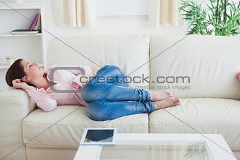 Casual woman resting on couch at home