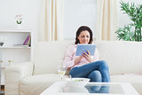 Casual woman using digital tablet at home