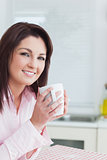 Smiling young woman with coffee cup