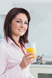 Smiling young woman with orange juice