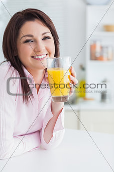 Closeup of young woman with orange juice