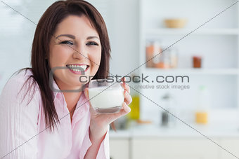 Portrait of woman with glass of milk