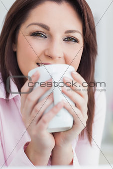 Closeup of woman with coffee cup