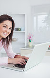 Portrait of smiling woman using laptop