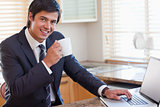 Business man using laptop and drinking coffee