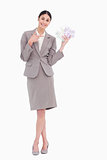 Portrait of happy business woman pointing at banknotes