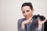 Portrait of business woman with binoculars smiling