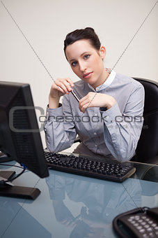 Business woman sitting in front of desktop computer