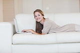 Portrait of woman using laptop on sofa