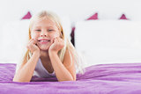 Little girl lying on a double bed