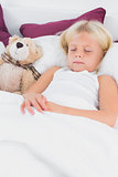 Little girl sleeping near to her teddy bear