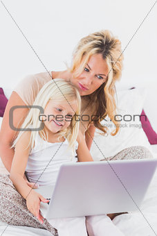Mother and her daughter using a laptop