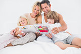 Smiling family reading a story together