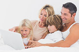 Family watching a laptop screen together