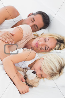 Calm family sleeping together