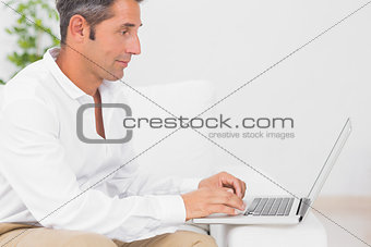Concentrated man using his laptop