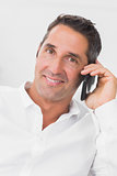 Man looking happy and talking on the phone