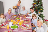 Mother bringing turkey to dinner table