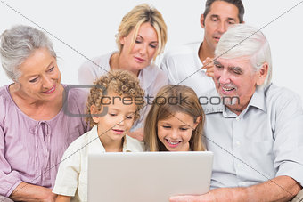 Joyful family watching a laptop screen together