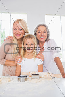 Smiling mothers and daughters cooking together