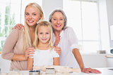 Cheerful mothers and daughters cooking together