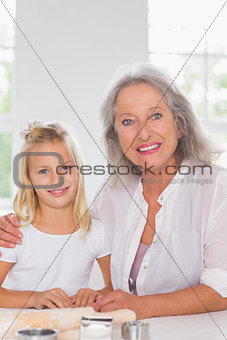 Grandmother and granddaughter looking at camera
