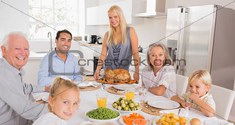 Happy mother serving a turkey