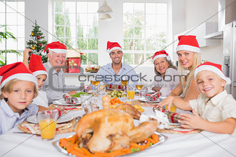 Smiling family around the dinner table at christmas
