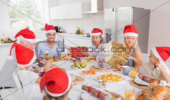 Smiling family around the dinner table at christmas