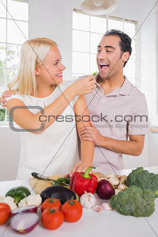 Wife giving vegetable to her husband