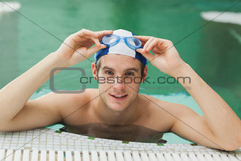 Man taking off his swimming goggles