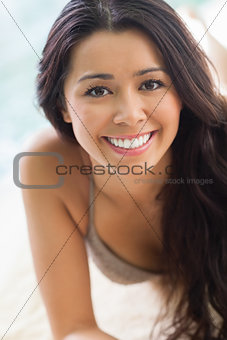 Smiling girl lying by the pool
