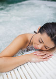 Woman resting at edge of jacuzzi
