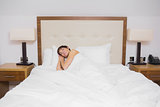 Brunette woman sleeping in bed