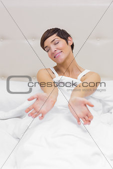Girl stretching in bed