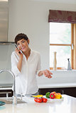 Woman calling in her kitchen