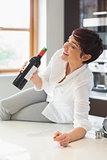 Woman drinking wine from the bottle