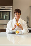 Woman drinking her orange juice at breakfast