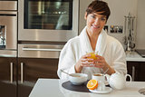 Woman drinking orange juice with breakfast