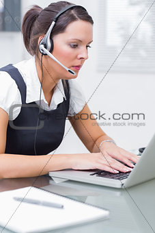 Business woman wearing headset in office