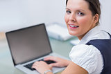 Portrait of business woman using laptop at desk