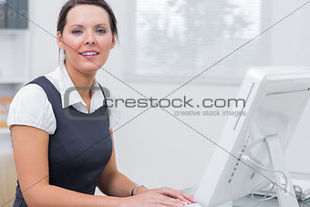 Confident female executive using computer at office