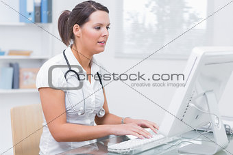 Female doctor using computer at clinic