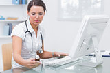 Doctor using computer to prepare an online prescription