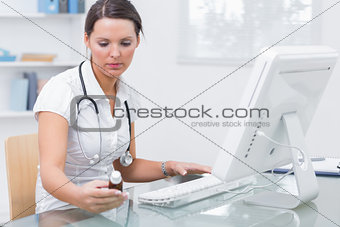 Doctor using computer to prepare an online prescription