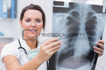 Female doctor holding xray at clinic